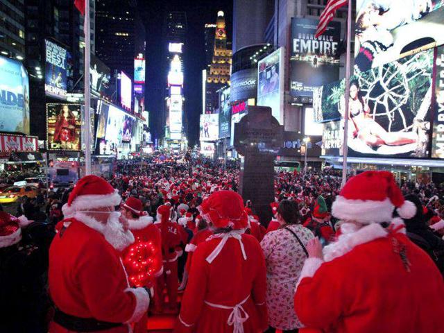 Thousand of people dressed in Santa Claus costume gather at Times Square during the annual SantaCon celebration in New York. REUTERS/Kena Betancur