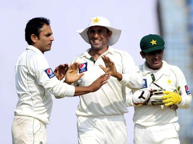 Pakistan's bowler Abdur Rehman (L) celebrates with his temamate Younis Khan (C) and Adnan Akmal (R) after the dismissal of the unseen Bangladeshi batsman Nazim Uddin during the fourth day of the first cricket Test match against Bangladesh in Chittagong. AFP Photo/Munir uz Zaman