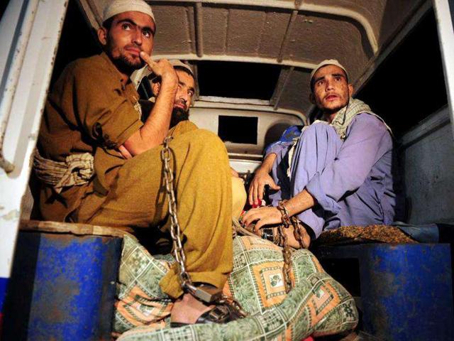 Rescued Pakistani students sit in a police vehicle following a police raid on Madrassa Zakarya in Karachi. Pakistani police rescued 45 students found chained in the basement during a raid on an Islamic seminary in the southern port city of Karachi, police said. According to government records, there are at least 15,148 seminaries in Pakistan with more than two million students -- around five percent of the 34 million children in formal education. AFP PHOTO/ASIF HASSAN