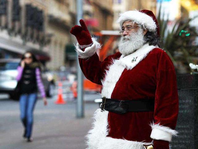 Salvation Army bell ringer Dave Seiler (R) waves to pedestrians in San Francisco, California. With less than two weeks before Christmas, San Franciscans are getting into the holiday spirit. (Justin Sullivan/Getty Images/AFP)