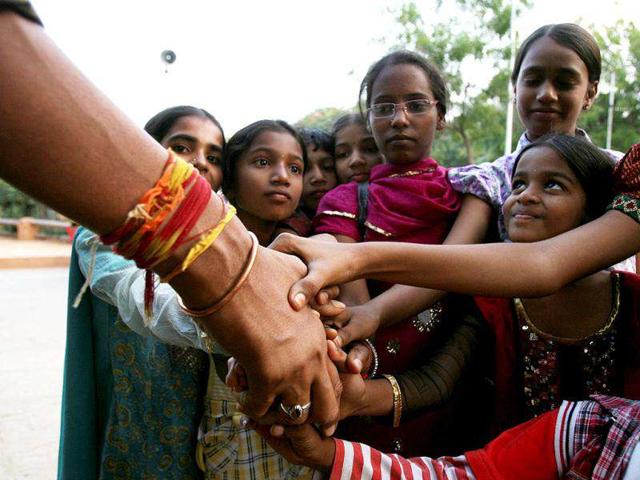 Visitors shake hands with Polipaka Gattaiah, who stands at seven-and-a-half feet and claims to be the tallest man in India, in Hyderabad. Reuters Photo