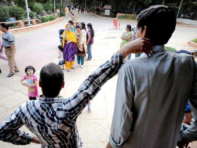 Visitors take pictures of Polipaka Gattaiah, who stands at seven-and-a-half feet. Reuters Photo