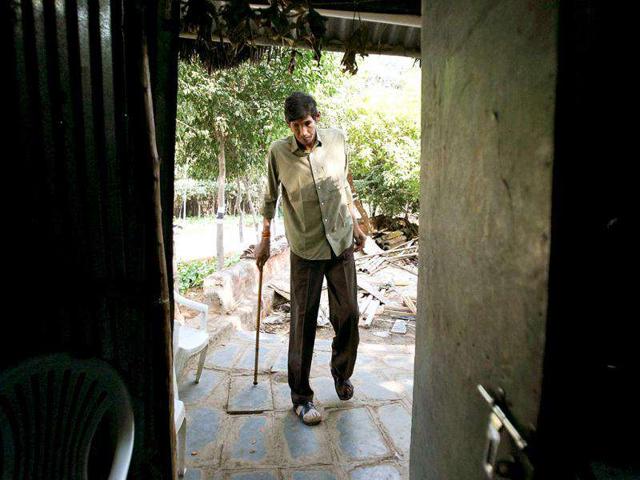 Polipaka Gattaiah, who stands at seven-and-a-half feet and claims to be the tallest man in India, walks to his room at the arts and crafts centre in Hyderabad. Reuters Photo