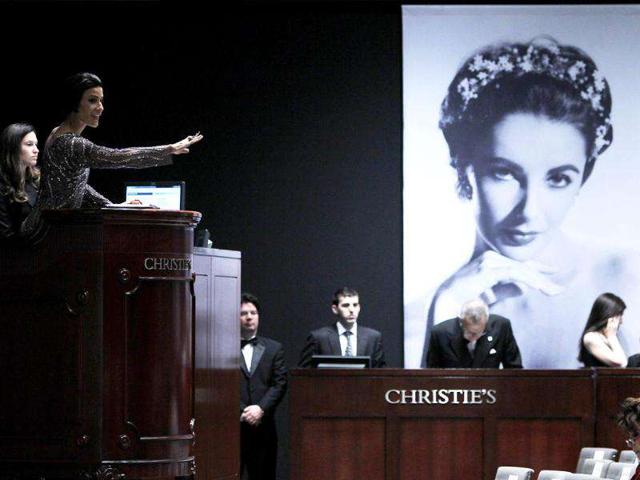 Christie's auctioneer Andrea Fiuczynski conducts an auction of Elizabeth Taylor's jewellery, clothing, art and memorabilia, near an image of the late actress at Christie's auction house in New York. Reuters Photo