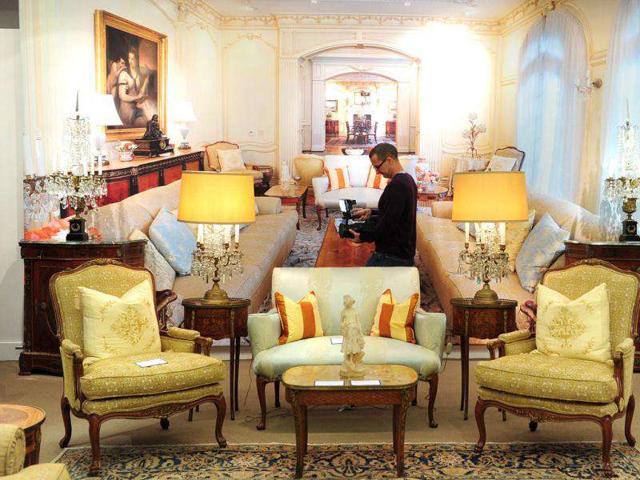 A cameraman films the display of items in a re-created room scene during a press preview for the sale of fine art and furnishings.(AFP PHOTO / Frederic J. Brown)