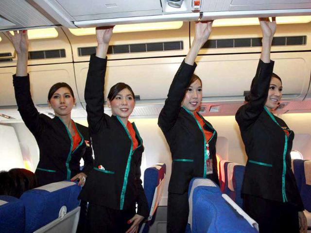 Thai transsexuals flight attendants, from left to right, Chayathisa Nakmai, Nathatai Sukkaset, Phuntakarn Sringern and Dissanai Chitpraphachin pose inside an airplane of PC Air during a flight in Thailand. AP Photo/Apichart Weerawong.