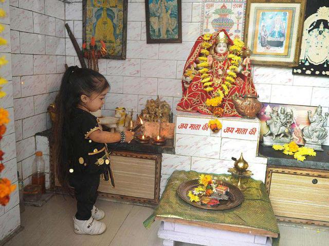 Jyoti Amge, 18, who stands at 62.8cm (24.7 inches), offers prayers near her residence in Nagpur. Amge was officially announced by the Guinness World Records the world's "shortest woman living (mobile)". 