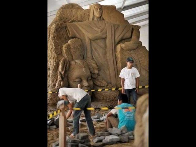 Workers clean the sand sculptures featuring world famous figures and landmarks during the 1st Sand Sculptures Festival at cultural park in Sentul outside of Jakarta, Indonesia. International artists from 11 countries created 40 large sand sculpture pieces of figures and land marks for the first Sand Sculptures Festival. (AFP/Bay Ismoyo)