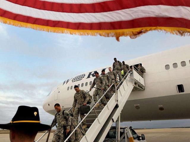 US Army soldiers from the 2-82 Field Artillery, 3rd Brigade, 1st Cavalry Division, walk off the plane as they arrive at their home base of Fort Hood, Texas after being part of one of the last American combat units to exit from Iraq in Fort Hood, Texas. The US military formally ended its mission in Iraq after eight years of war and the overthrow of Saddam Hussein.