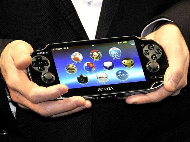 Japan's video game giant Sony Compuer Entertainment (SCE) president Andrew House displays the new portable video game console "PlayStation Vita" (PS Vita) at the launching event in a video game shop in Tokyo. Sony will put the new gaming system on the market in the United States and Europe in February 2012.