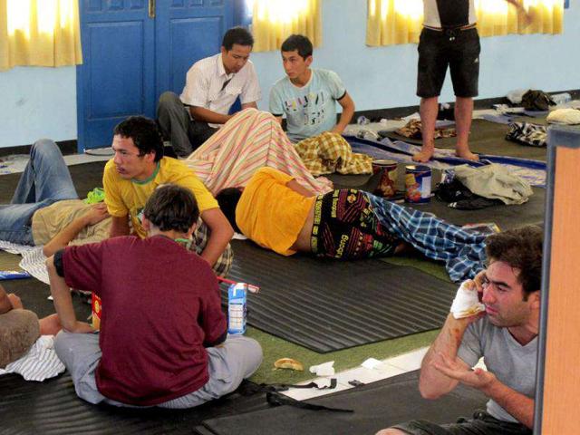 Asylum seekers who survived a wreck take a rest at a temporary shelter in Trenggalek, East Java, Indonesia.