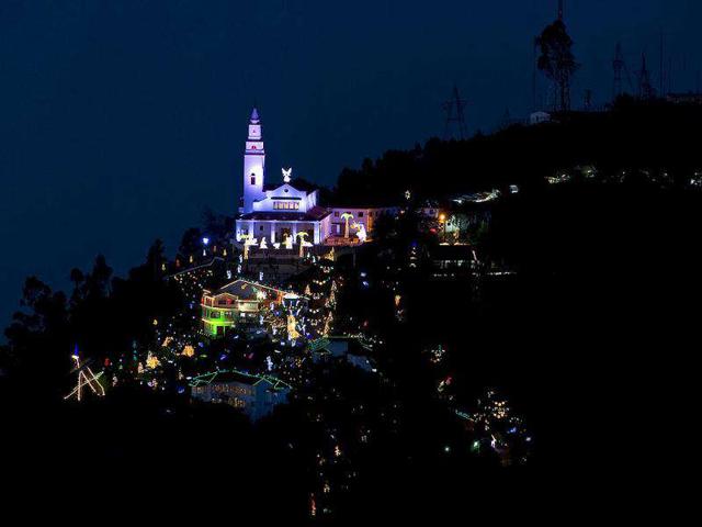 Photo taken from Guadalupe Mountain of the sanctuary Basilica of the Fallen Lord of Montserrate, decorated with Christmas lights, at the Monserrate hill, in Bogota.
