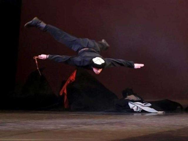A dancer of the Igor Moiseyev (Moisseiev) Russian ballet, who is celebrating his 75th birthday, performs on stage at the Palais des Congres in Paris. AFP/Francois Guillot
