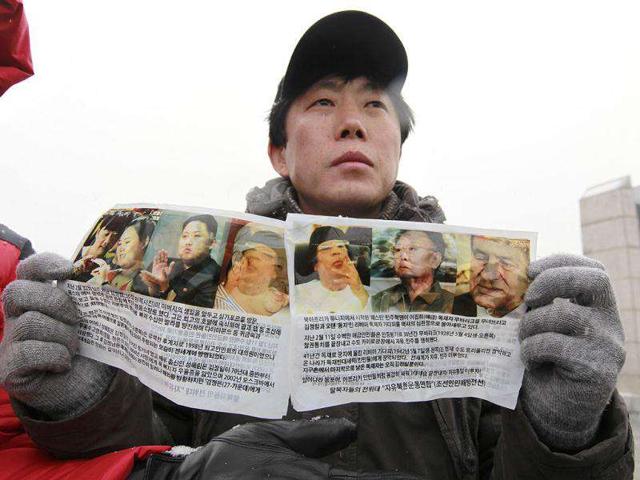 Park Sang-hak, a North Korean defector and an anti-North Korea activist living in South Korea, shows anti-North Korea leaflets toward the North before sending them by balloons at the Imjinkak pavilion, near the demilitarized zone which separates the two Koreas in Paju, about 50 km north of Seoul. Reuters/Kim Kyung-Hoon