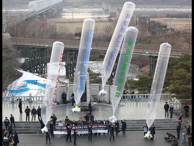 North Korean defectors who live in South Korea prepare to fly balloons carrying anti-North Korea leaflets at the Imjinkak pavilion, near the demilitarized zone which separates the two Koreas in Paju, about 50 km north of Seoul. The slogans on the balloons read "Liberate North Korean compatriot" , "Terminated three generation hereditary power transfer", "Go to hell, Kim Jong-il", "No condolence call to devil" and "North Koreans, uprising". Reuters/Kim Kyung-Hoon