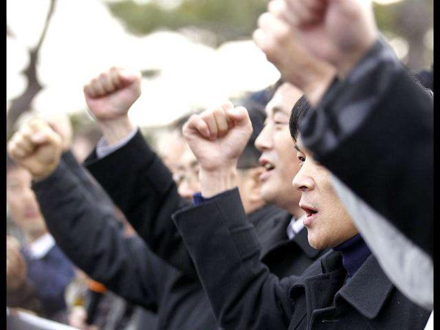 North Korean defectors who live in South Korea shout slogans before releasing balloons carrying anti-North Korea leaflets at the Imjinkak pavilion, near the demilitarized zone which separates the two Koreas in Paju, about 50 km north of Seoul. The defector groups who released 200,000 anti-North Korea leaflets, celebrated the death of North Korean leader Kim Jong-il and protested against condolences to the dictator's death. Reuters/Kim Kyung-Hoon