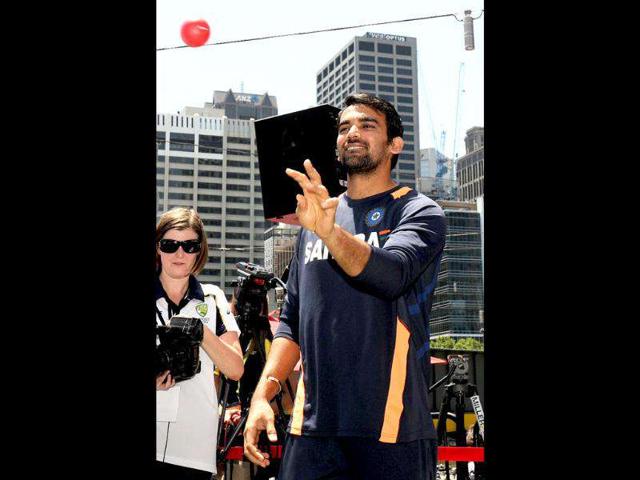 Cricketer Zaheer Khan bowls a ball to a young fan as members of the Indian and Australian teams meet a large crowd at a public event in Melbourne. AFP Photo/William West