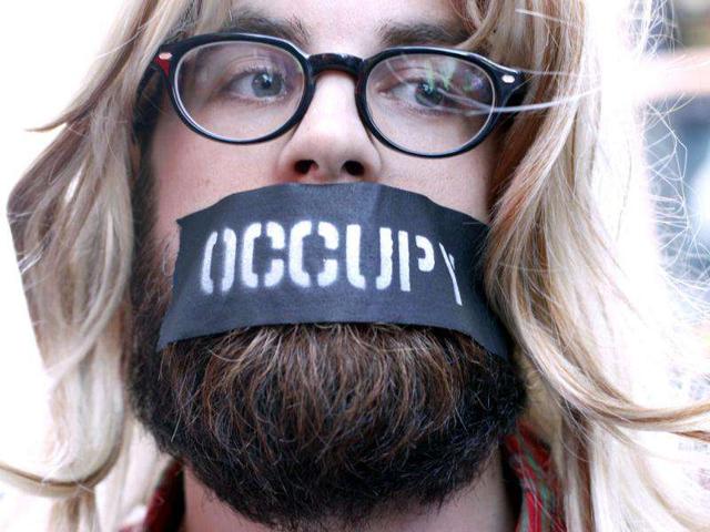 An Occupy Wall Street protester joins a demonstration at Times Square, New York. A protest movement which began in Zuccotti Park, in New York City, against social and economic inequality, high unemployment, greed and corruption spread across to over 80 cities across the globe. Reuters