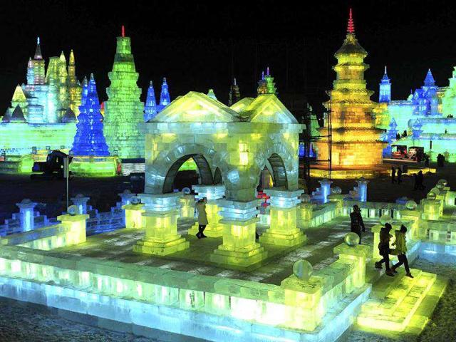 Tourists visit ice sculptures during the lights testing period of the 13th Harbin Ice and Snow World in Harbin, Heilongjiang province. The Harbin International Ice and Snow Festival will be officially launched on January 5, 2012. REUTERS/Sheng Li