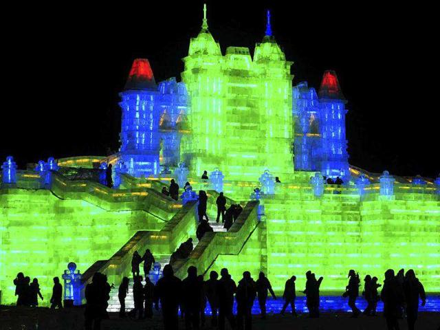 Tourists visit ice sculptures during the the lights testing period of the 13th Harbin Ice and Snow World in Harbin, Heilongjiang province. The Harbin International Ice and Snow Festival will be officially launched on January 5, 2012.REUTERS/Sheng Li
