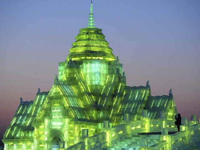 A tourist records video on ice sculptures during the lights testing period of the 13th Harbin Ice and Snow World in Harbin, Heilongjiang province. The Harbin International Ice and Snow Festival will be officially launched on January 5, 2012. REUTERS/Sheng Li