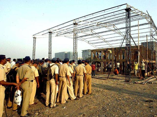 Police officers stand near the stage where social activist Anna Hazare will fast at MMRDA grounds in Mumbai. PTI Photo