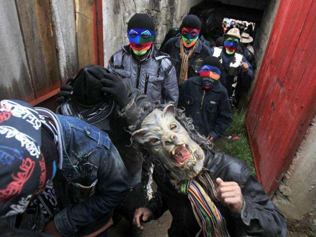 Andean men wearing masks enter the ring to participate in fights during the "Takanakuy", a traditional festivity at Chumbivilcas province in Cuzco.