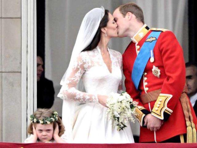 Britain's Prince William kisses his wife Kate, Duchess of Cambridge, on the balcony of Buckingham Palace, after their wedding service, on April 29, 2011, in London. (AFP)
