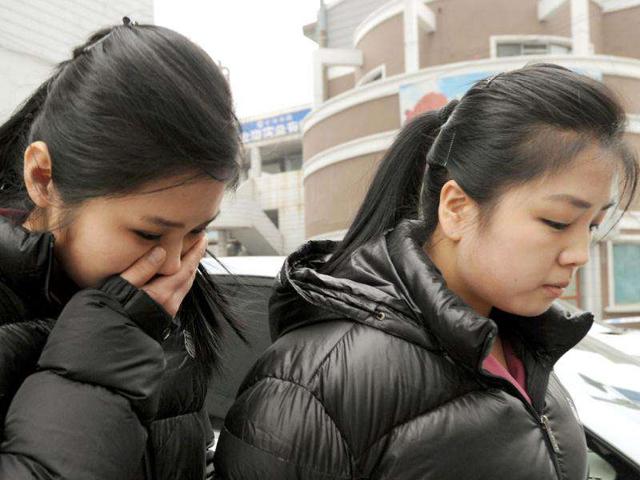 North Korean mourners leave a Korean restaurant after watching a telecast of the funeral of the late leader Kim Jong-Il, at the North Korean and Chinese border town of Dandong. North Korea on December 28 began the funeral of late leader Kim Jong-Il, Russian media reported from a snowy Pyongyang, as the grieving communist state bolstered his son's status as "great successor". AFP Photo/Mark Ralston