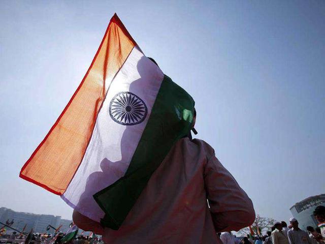 A supporter of Anna Hazare carries his child on his shoulders while holding a national flag during Hazare's three-day fast at the Bandra-Kurla Complex grounds in Mumbai. Reuters Photo