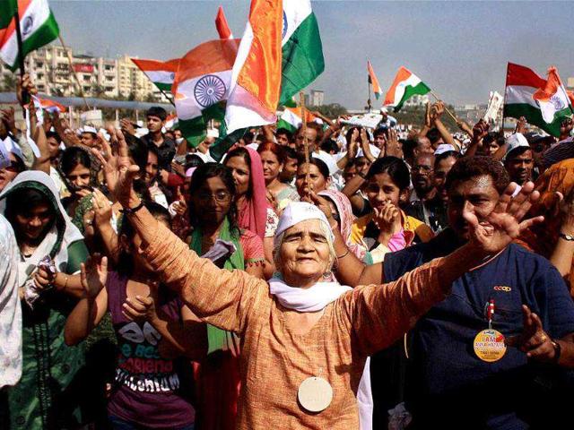 Supporters of Anna Hazare wave the tri-colour on the second day of his fast for stronger Lokpal Bill at MMRDA ground in Mumbai. PTI Photo