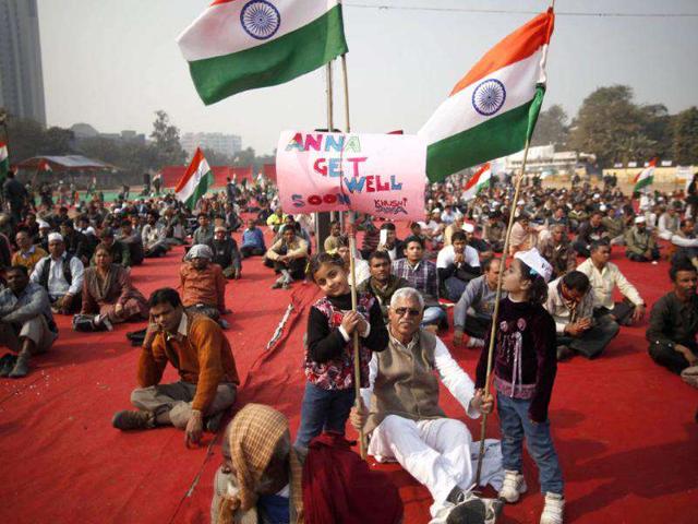 Supporters of Anna Hazare display a placard wishing him fast recovery as they attend a protest rally in New Delhi. AP Photo