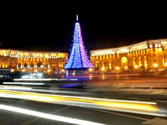 A long camera exposure picture taken shows streaks of lights of the cars driving past an illuminated New Year tree at the central Republic Square in the Armenian capital Yerevan. AFP photo/Karen Minasyan