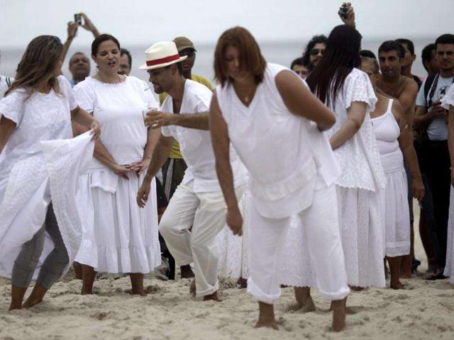 Worshippers of Afro-Brazilian religion Umbanda attend a ceremony in tribute to Iemanja, the goddess of the sea, in Copacabana Beach in Rio de Janeiro.