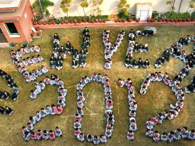 School children form a human chain that reads New Year 2012 to welcome the new year in Gurgaon. PTI Photo