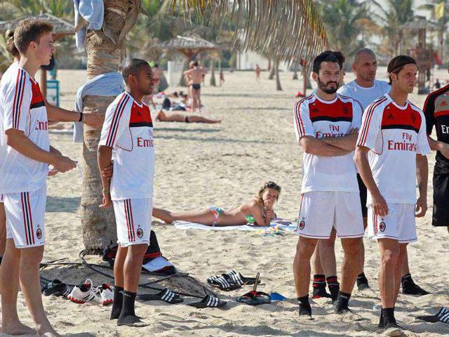 AC Milan players wait for the start of a training session at Al-Mamzar Beach in the Gulf emirate of Dubai. The Italian champions will face Qatar-backed French club Paris Saint-Germain in the Challenge Cup on January 4, 2012. AFP PHOTO