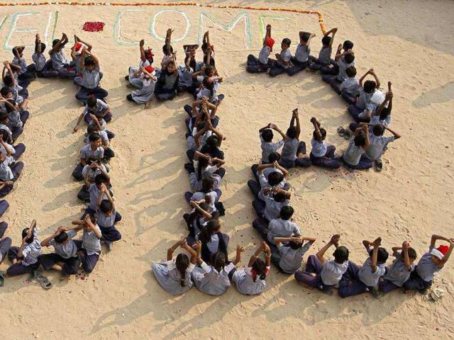 Students sit in a formation during their New Year's Day celebrations at a school in Ahmedabad. Reuters Photo