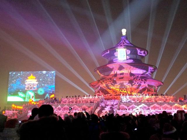 People gather to celebrate the new year 2012 at the illuminated Temple of Heaven, the city's historic landmark in Beijing. AFP Photo