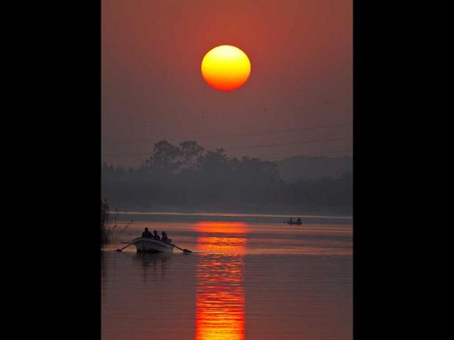 Pakistani tourists enjoy a boat ride on Rawal lake as the sun sets in Islamabad, Pakistan. AP