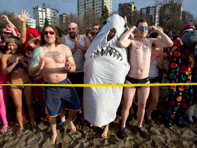 Participants prepare to enter the frigid waters of English Bay during the 92nd annual Polar Bear Swim in Vancouver, B.C. (AP Photo/The Canadian Press, Darryl Dyck)