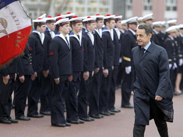 French President Nicolas Sarkozy reviews the troops prior to his New Year's speech at the Naval academy in Lanveoc-Poulmicin, north-western France. AP/Michel Euler, Pool