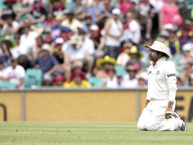 Sachin Tendulkar kneels on the ground after he caught out Australia's Ricky Ponting on day 2 of the second test match at the SCG in Sydney, Australia.(AP Photo/Rob Griffith)