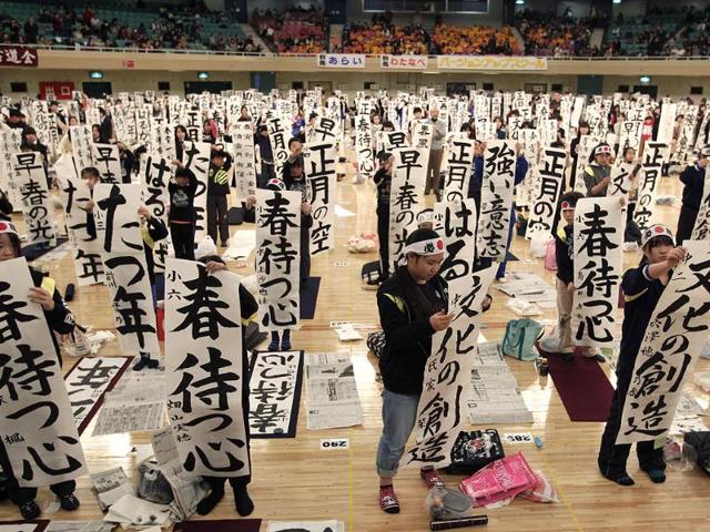 Participants show off their works at the New Year calligraphy contest in Tokyo. (AP Photo/Shizuo Kambayashi)