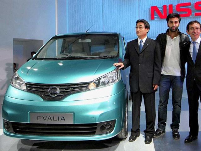 Ranbir Kapoor and Nissan officials pose with the company's Evalia car at the 11th Auto Expo 2012 at Pragati Maidan in New Delhi. PTI Photo by Kamal Singh