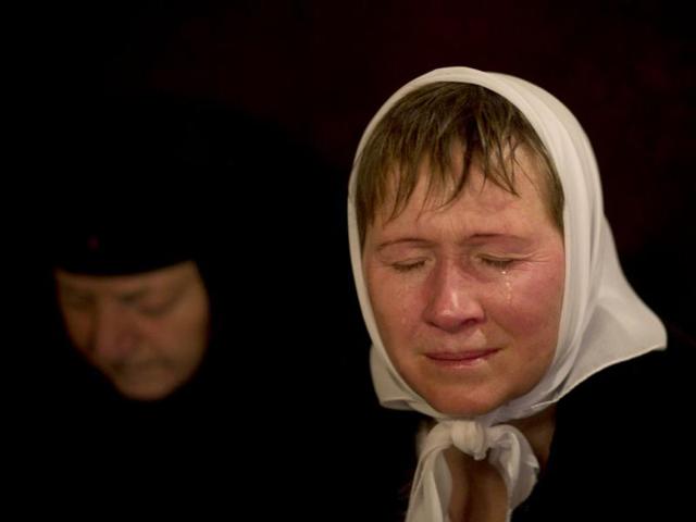 An orthodox worshipper cries inside the Church of the Nativity, traditionally believed by Christians to be the birthplace of Jesus Christ, during Orthodox Christmas celebrations in the West Bank city of Bethlehem. (AP Photo/Bernat Armangue)