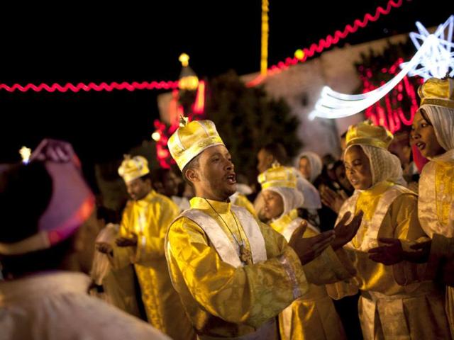 Worshippers celebrate Orthodox Christmas in the West Bank city of Bethlehem. (AP Photo/Bernat Armangue)