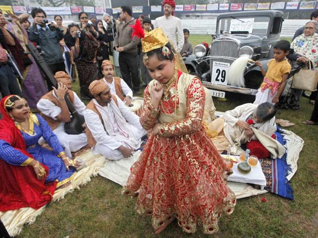 A participant wearing a fancy dress poses in front of a 1932 Chevrolet car in Kolkata.Reuters/Rupak De Chowdhuri
