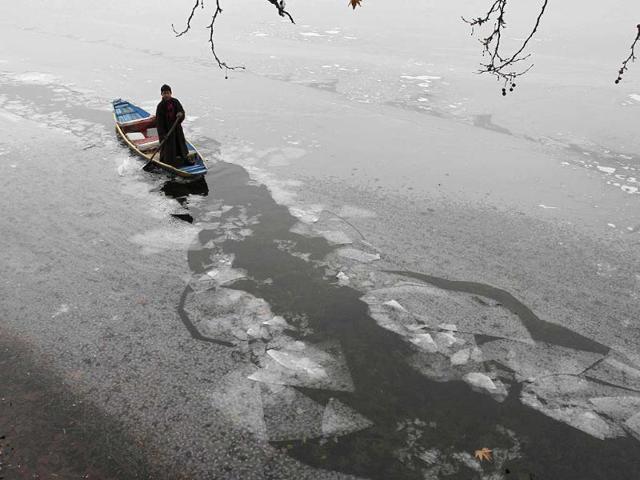 A Kashmiri boy rows a traditional boat on the Dal Lake in Srinagar. Many parts of northern India received snowfall in recent days, closing roads and hindering transport in some parts of the region including the main highway in Jammu and Kashmir. (AP Photo/Mukhtar Khan)
