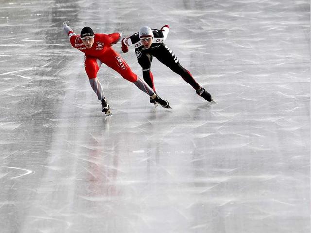 Havard Bokko (L) of Norway and Haralds Silovs of Latvia compete at the 1500 metres race during the European speed skating championship in Budapest. Reuters photo/Laszlo Balogh
