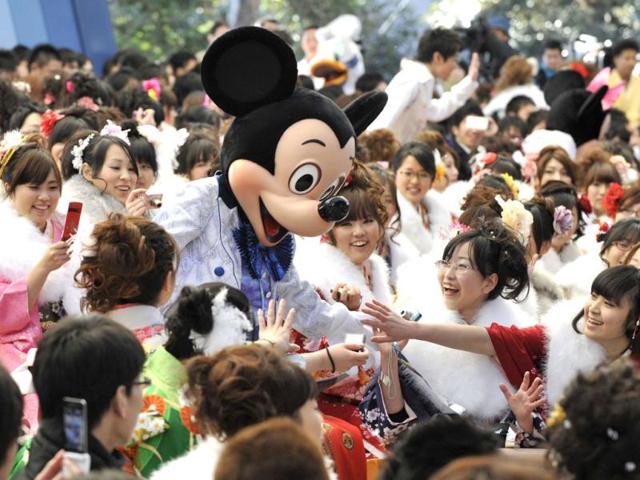Women wearing kimonos gather at the Tokyo Disneyland to attend the annual coming-of-age day ceremony hosted by Urayasu city. (AFP Photo/Kazuhiro Nogi)